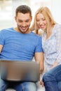 Smiling happy couple with laptop at home Royalty Free Stock Photo