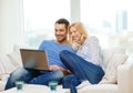 Smiling happy couple with laptop at home Royalty Free Stock Photo