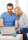 Smiling happy couple with laptop at home Royalty Free Stock Photo