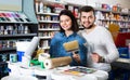 Couple purchasing tools for house improvements in paint supplies store Royalty Free Stock Photo