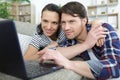 smiling happy couple using laptop Royalty Free Stock Photo