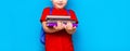 Smiling happy cute clever boy with backpack. Child with a pile of books in his hands. blue background. Ready for school. Back to Royalty Free Stock Photo