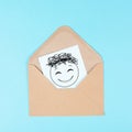 Smiling happy face on a paper inside an evelope, positive emotions, good customer feedback, greeting card