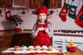 Festive red apron Christmas party dinner dessert peppermint cupcakes cheese cream sugar sprinkling decoration girl new Royalty Free Stock Photo