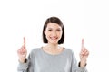 Smiling happy girl pointing two fingers up at copy space Royalty Free Stock Photo