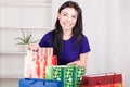 Smiling happy girl prepares bags gifts for Christmas Royalty Free Stock Photo