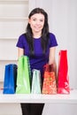 Smiling happy girl prepares bags gifts for Christmas Royalty Free Stock Photo