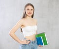 Smiling happy girl student hold books on gray background studio portrait. Education in high school university college Royalty Free Stock Photo