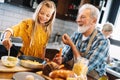 Smiling grandfather helping children to cook in the kitchen Royalty Free Stock Photo