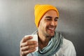 Smiling and happy handsome young man drinking coffee, tea, water, with white mug. Royalty Free Stock Photo