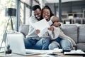 Smiling, happy and hugging couple enjoying, embracing and loving remote work together at home. Young romantic partners Royalty Free Stock Photo