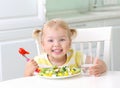 Smiling happy kid eating healthy food vegetables salad Royalty Free Stock Photo