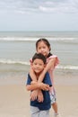 Smiling happy kids on the beach. Asian boy kid and girl child at the beach during family summer vacation Royalty Free Stock Photo