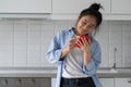 Smiling happy Korean girl messaging on smartphone at home, internet use and happiness Royalty Free Stock Photo