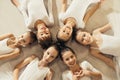 Smiling happy little girls ballerinas lying on floor in circle Royalty Free Stock Photo