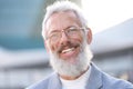 Smiling happy mature older business man standing outdoors, headshot portrait. Royalty Free Stock Photo