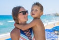 Smiling and happy mother and her son playing the beach. Concept of friendly family. Miami beach. Royalty Free Stock Photo