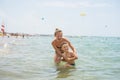 Smiling and happy mother and her son playing and running on the beach. Concept of friendly family Royalty Free Stock Photo
