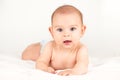 Smiling happy newborn infant baby tummy time on bed bright airy copy space childhood Royalty Free Stock Photo