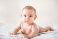 Smiling happy newborn infant baby tummy time on bed bright airy copy space childhood Royalty Free Stock Photo