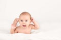 Smiling happy newborn infant baby tummy time on bed bright airy copy Royalty Free Stock Photo