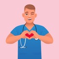 A smiling, happy nurse with a stethoscope shows a heart symbol with his hands. Cute white young male doctor