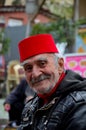 Smiling happy old Turkish man in fez and leather jacket