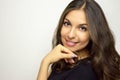 Smiling, happy, positive, carefree young woman face looking at camera with blank space to the side, head and shoulder shot