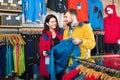 Couple examining track jackets in sports clothes store Royalty Free Stock Photo