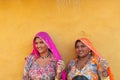 Smiling and happy Rajasthani women in local costume, posing in a Rajasthani village