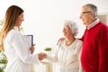 Smiling and happy senior couple visiting a doctor Royalty Free Stock Photo