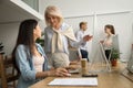 Smiling happy senior executive talking to asian employee at work Royalty Free Stock Photo