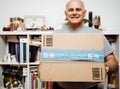 Smiling happy senior man holding Amazon Prime cardboard