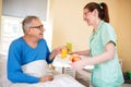 Smiling happy senior patient waiting breakfast at nursing home