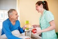 Smiling happy senior patient waiting breakfast at nursing home