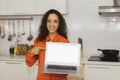 Smiling happy Spanish beautiful woman holding a laptop PC on a white background in an old rose shirt. Happy smile in the modern ki Royalty Free Stock Photo