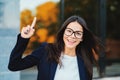 Smiling happy student girl showing eureka gesture. Portrait of young thinking pondering business woman having idea Royalty Free Stock Photo