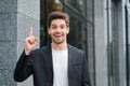 Smiling happy student man showing eureka gesture. Portrait of young thinking pondering businessman having idea moment Royalty Free Stock Photo