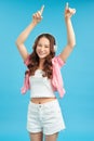 Smiling happy teenager girl portrait on blue wall background. Beauty teen style Royalty Free Stock Photo