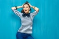 Smiling happy teenager girl portrait on blue wall background. Royalty Free Stock Photo