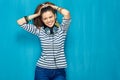 Smiling happy teenager girl portrait on blue wall background. Royalty Free Stock Photo