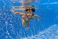 Smiling happy underwater kid in swimming pool