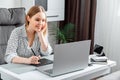 Smiling happy Woman designer using graphic tablet and laptop for work in home office. Freelance retoucher illustrator Royalty Free Stock Photo