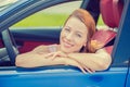 Smiling happy woman sitting in a new blue car Royalty Free Stock Photo