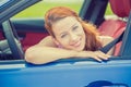 Smiling happy woman sitting in a new blue car Royalty Free Stock Photo