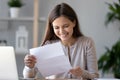 Smiling happy woman student or worker reading good news in paper letter Royalty Free Stock Photo