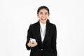 Smiling happy young Asian business woman in suit holding mobile smart phone over white isolated background Royalty Free Stock Photo