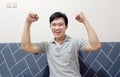 a smiling happy young asian man is excited and celebrating win and success Royalty Free Stock Photo