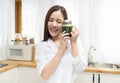 Smiling happy young Asian woman drinking fresh raw green detox vegetable juice at home. Healthy Food Eating, Diet And Lifestyle Royalty Free Stock Photo
