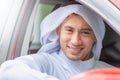 Smiling happy young business arab middle eastern muslim man sitting in the car